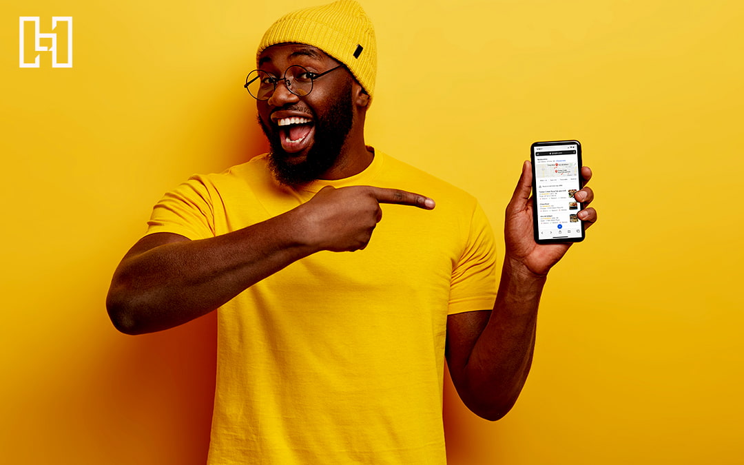 Featured graphic of a man pointing at his phone