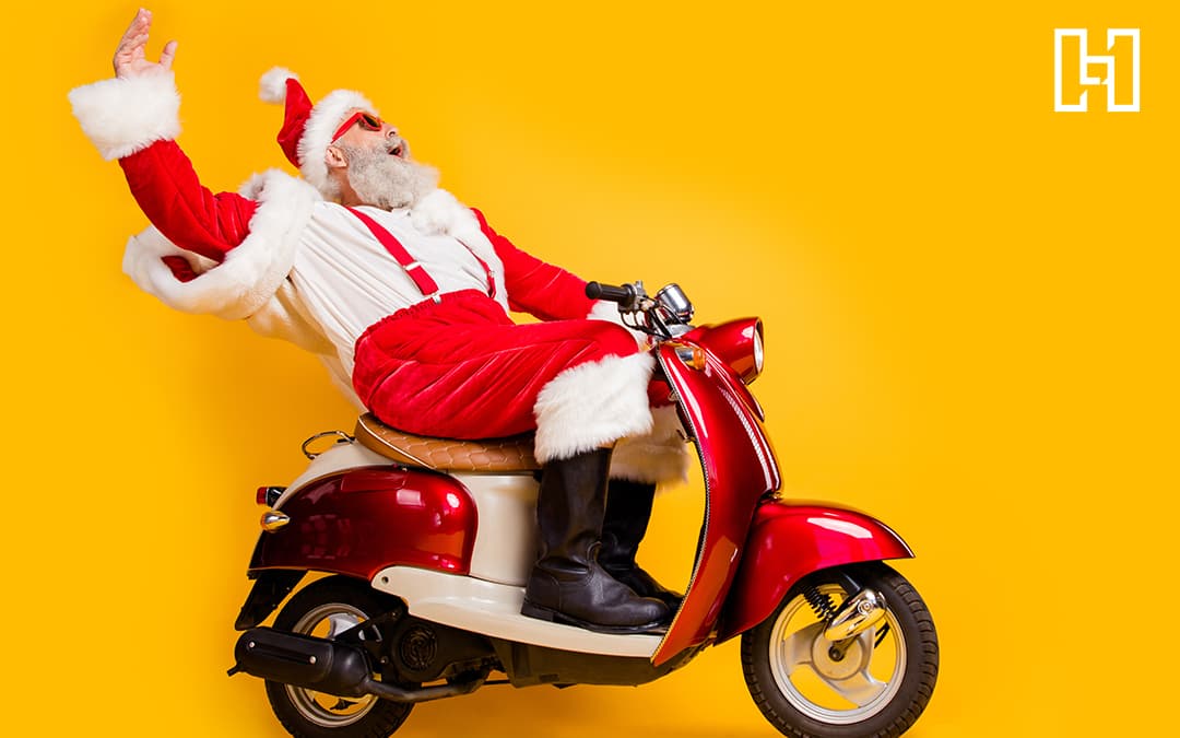 Man Dresssed Up as Santa Riding a Vespa