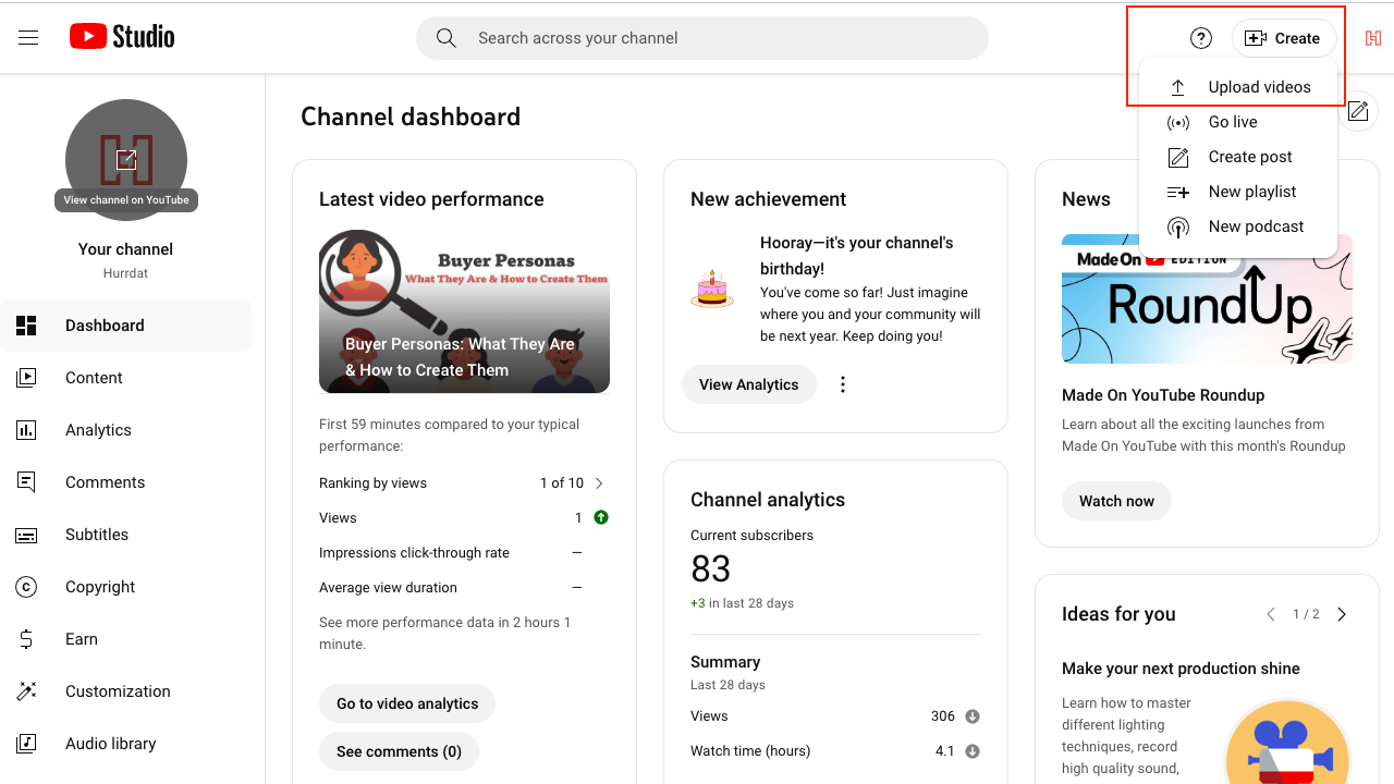 Screenshot of YouTube channel dashboard when logged in on desktop with Create button selected in top right corner of screen and drop-down menu showing "Upload Videos" option